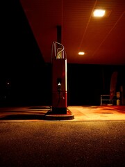 Sticker - Vertical shot of a fuel dispenser at an empty gas station at night