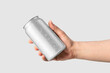 Aluminium drink can 330ml with water drops in a hand mockup template, isolated on light grey background. High resolution.