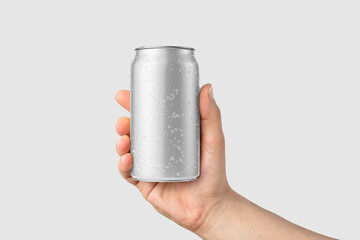 Wall Mural - Aluminium drink can 330ml with water drops in a hand mockup template, isolated on light grey background. High resolution.