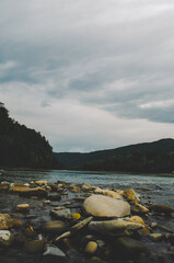 Wall Mural - mountain river between sheer cliffs . blue clear water of the river. Young green leaves of trees