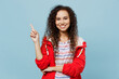 © ViDi Studio - Young woman of African American ethnicity in red jacket point index finger aside indicate on workspace area mock up isolated on plain pastel light blue cyan background Wet fall weather season concept.
