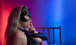 © rotozey - Sexy girl in bdsm cat mask sucks finger in neon light