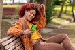 © carballo - latin black woman with mobile phone on bench sitting in autumn