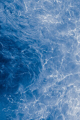  Blue purple sea surface with waves, splash and bubbles