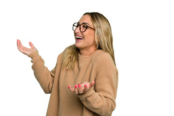 Wall Mural - Young caucasian woman isolated on green chroma background joyful laughing a lot. Happiness concept.