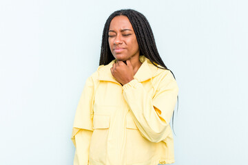 Wall Mural - Young African American woman with braids hair isolated on blue background suffers pain in throat due a virus or infection.