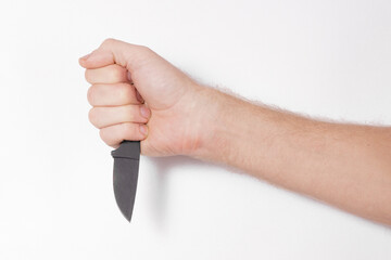 Poster - male hand holding a small black knife on a white