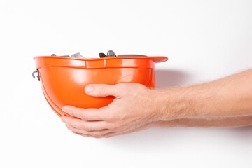 Poster - male hand holding orange building paint isolated on white