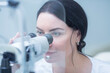 © Olga - a young ophthalmologist woman looks into the viewfinder of a slit lamp for biomicroscopy of the eye