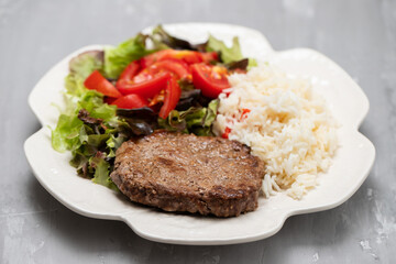 Wall Mural - three fried ground meat with fresh salad on white plate