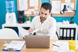 © Krakenimages.com - Young hispanic man business worker using laptop reading document at office