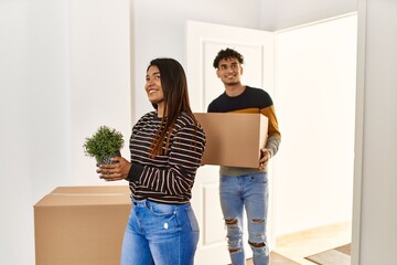 Poster - Young latin couple smiling happy getting in at new home.