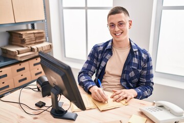 Sticker - Young hispanic man ecommerce business worker writing on package at office