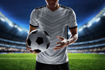 Wall Mural - Soccer player holding ball in the stadium