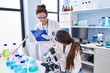 © Krakenimages.com - Woman and girl wearing scientist uniform using microscope at laboratory