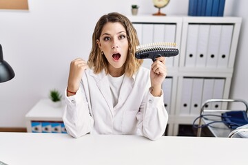 Sticker - Young hispanic woman working at dentist clinic holding whitening test scared and amazed with open mouth for surprise, disbelief face