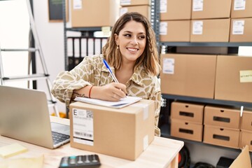 Young hispanic woman smiling confident working at office