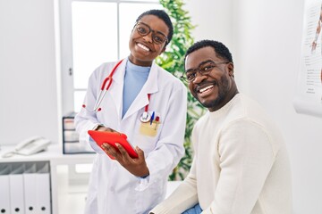 Poster - Man and woman doctor and patient having medical consultation using touchpad at clinic