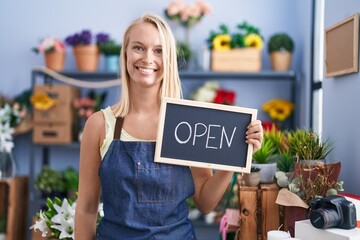 Sticker - Young caucasian woman working at florist with open sign looking positive and happy standing and smiling with a confident smile showing teeth