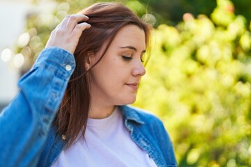 Young beautiful plus size woman smiling confident looking to the side at park