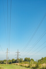 Wall Mural - Power line towers. Out-of-town power supply system. Energy infrastructure in the fields in the countryside.