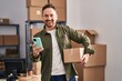 © Krakenimages.com - Young caucasian man ecommerce business worker using smartphone holding package at office