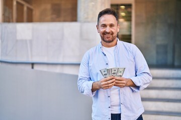 Sticker - Young caucasian man smiling confident counting dollars at street