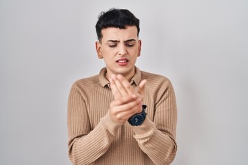 Sticker - Non binary person standing over isolated background suffering pain on hands and fingers, arthritis inflammation