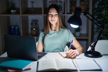 Canvas Print - Teenager girl doing homework at home late at night looking to side, relax profile pose with natural face and confident smile.