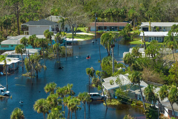 Poster - Surrounded by hurricane Ian rainfall flood waters homes in Florida residential area. Consequences of natural disaster