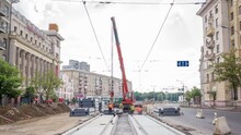 Installing Concrete Plates By Crane At Road Construction Site Panoramic Timelapse. Industrial Workers With Hardhats And Uniform. Reconstruction Of Tram Tracks In The City Street