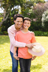 Wall Mural - Caucasian mother and son spending time together in the garden