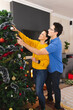 © wavebreak3 - Vertical picture of caucasian couple spending time together decorating the christmas tree