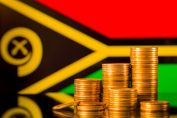 A stack of gold coins on the background of the flag of Vanuatu. Country economy concept