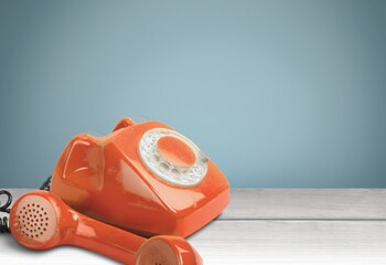 Canvas Print - A retro red old telephone on a table.