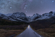 Car On Road Under Starry Sky At Night