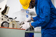 © winnievinzence - experienced operator technician worker or engineer metalworker industrial in safety helmet working or repair on metal machine, professional maintenance skill man in industry manufacturing. men at work