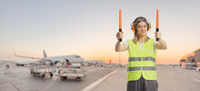 Female Aircraft Marshaller With Wands Working On An Airport Apron