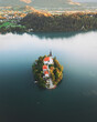 © AmazingAerialAgency - Aerial view of the church Marijinega Vnebovzetja at sunset, Lake Bled, Slovenia.
