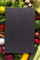 Wall Mural - Variety of fresh vegetables slate stone at table background. Cooking concept and salad ingredients