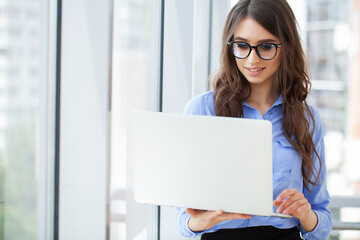 Wall Mural - Business woman busy working on laptop computer at office.