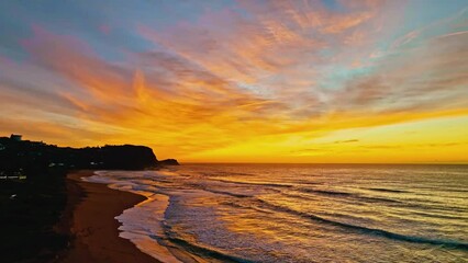 Wall Mural - Aerial sunrise with high clouds and gentle sea at Avoca Lagoon and Avoca Beach on the Central Coast, NSW, Australia.