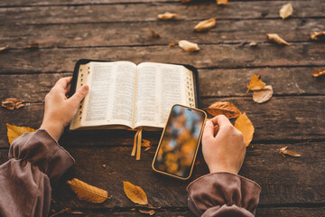 Open book on wood planks over outdoor natural background