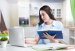 © BillionPhotos.com - Smiling student woman study with books at home