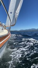 Footage Of A Sailboat Sailing Along With Sails Up And Tilted By The Wind, British Columbia