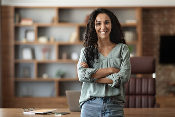 Poster - Happy young woman posing at office, smiling at camera