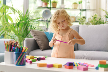 Wall Mural - Cute girl coloring with markers