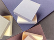 colorful square sponge foam pieces neatly arranged in a square shape. a collection of pastel colored soft materials with different thickness
