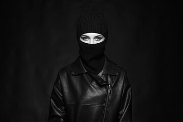 Wall Mural - Fashionable girl in balaclava and leather coat. Black and white portrait