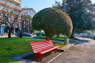 Sticker - The red bench and topiary plants in lakeside park, Locarno, Switzerland